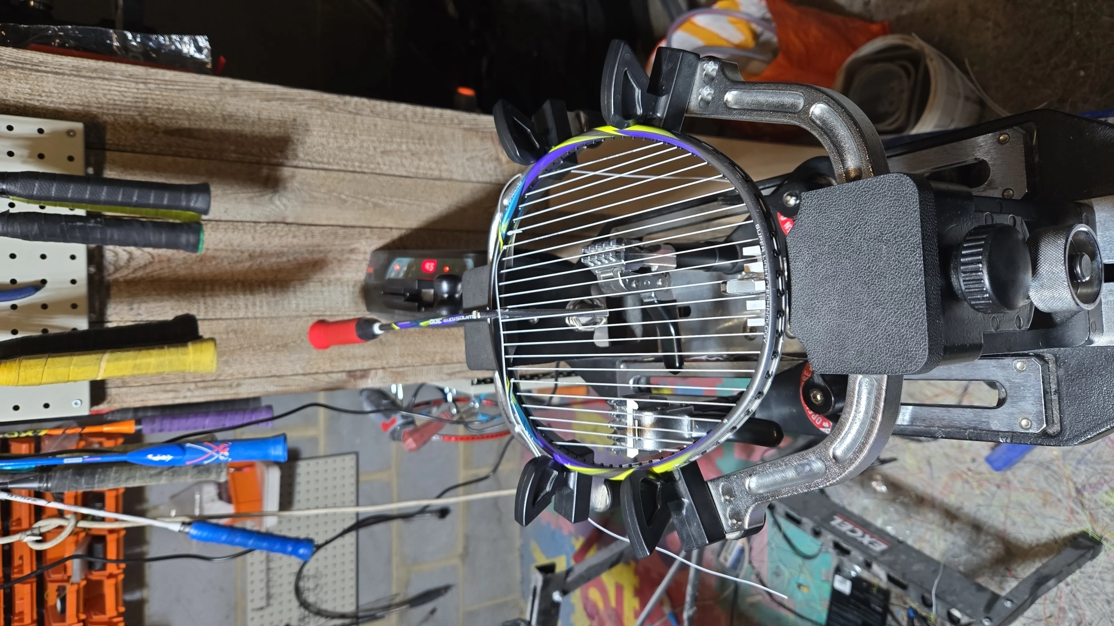 Close-up of badminton racket stringing machine setup